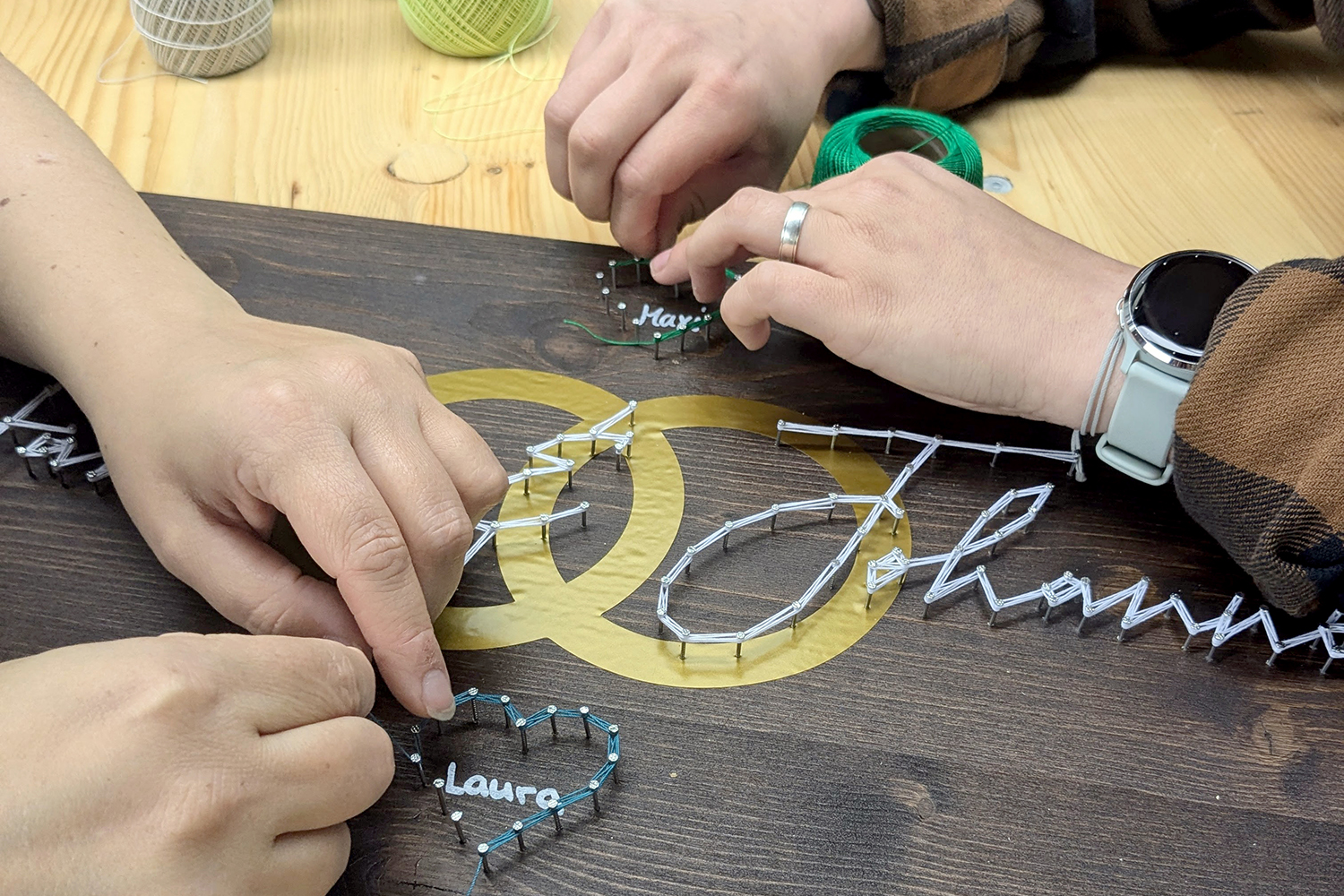 A string art picture is made by multiple people by hand with a DIY set